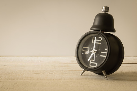 Vintage alarm clock on wood background