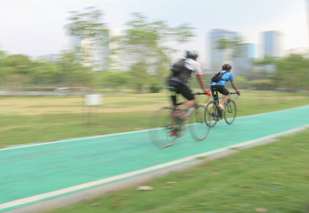 Bicycle rider on a bicycle path in park , motion blur