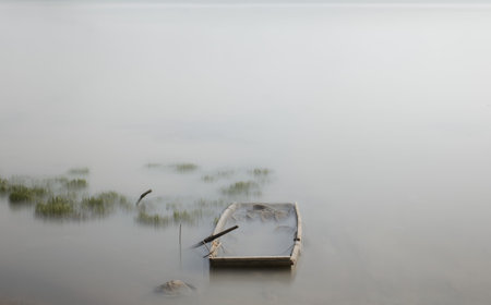 fishing boat in the lake in the misty morning, Thailandの写真素材