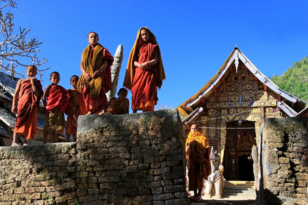 Kengtung, Shan State, Myanmar - 1 January 2011 : Little monk stand on the wall of golden temple at Kengtung, Shan State, Myanmar on new year 1 January 2011のeditorial素材