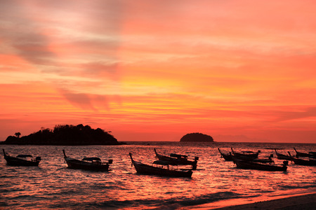 Beautiful Sunset and local fishing boats on seaside at Lipe island, Andaman sea, Satun, Thailand.の写真素材