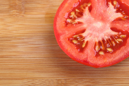 Top view of half tomato on wooden background. sliced tomato.の写真素材