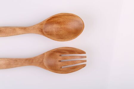 Wooden spoon and wooden fork isolated on white background.の写真素材