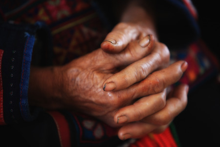 Old tribal woman with wrinkle hands clasped.の写真素材