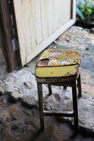 Very old wooden chair with iron pad on top.の写真素材
