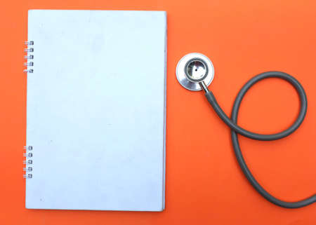 A stethoscope and a red heart are on the green doctor table.health and medical conceptsの写真素材