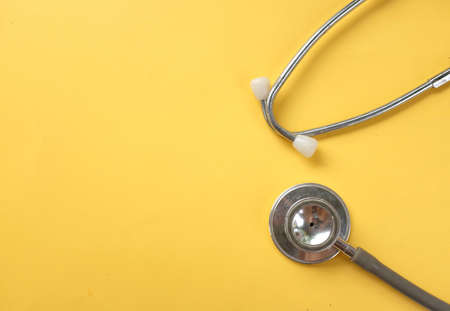 flat lay and copy space stethoscope isolate on a yellow backgroundの写真素材
