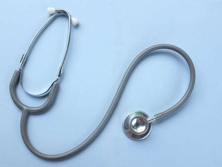 flat lay and top view stethoscope isolate on a gray Doctor's desk background.
concept Health care and 
Treating the sickの写真素材