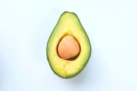 Half avocado on a white background. Healthy eating conceptの写真素材
