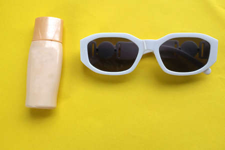 top view and flat lay black magnifying glass and calculator on yellow background.Business and finanse conceptの写真素材