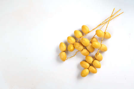 top view and flat lay fresh palm Phoenix dactylifera or Date palm fruit isolated on the white backgroundの写真素材