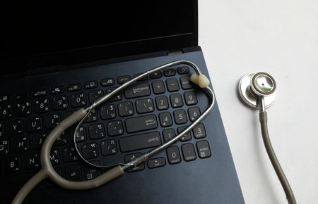 Stethoscope and laptop on white background. Healthcare and medical concept.