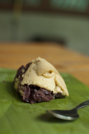 Black Sticky Rice with Custard Topping on Banana Leafの写真素材
