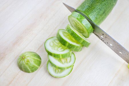 knife cutting cucumberの写真素材