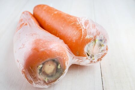 carrots in plastic wrapの写真素材