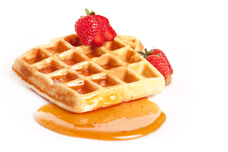 Belgian waffles with syrup, topping with strawberryの写真素材