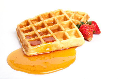 Belgian waffles with syrup and strawberryの写真素材