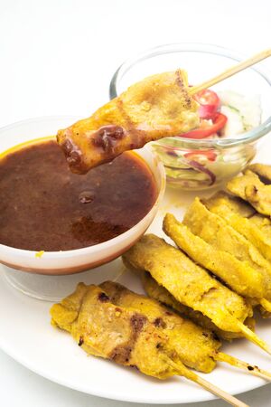pork satay with peanut dipping sauceの写真素材