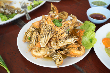 Fried mantis shrimps with garlic on white plateの写真素材