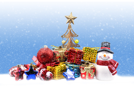 Christmas background with ornaments, gift box, tree and snowmanの写真素材