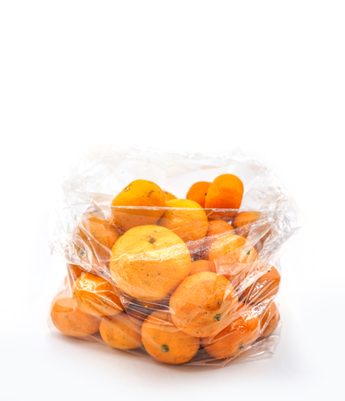 Mandarins in plastic bag isolated on whiteの写真素材