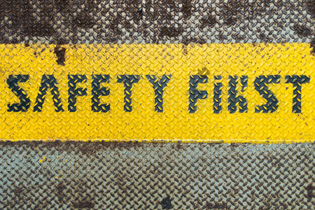 Safety First sign on caution stripの写真素材