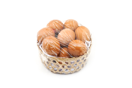 brown eggs in bamboo basket with plastic wrapの写真素材
