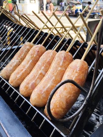 Thai sausage style - easten thai sausage on stainless barbeque gridの写真素材