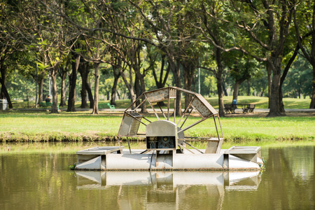 water mill making good water environment in parkの写真素材