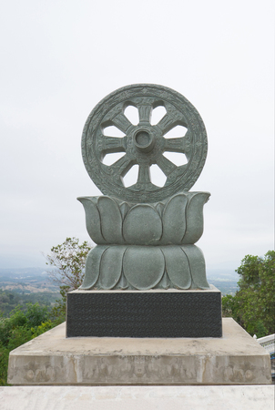 buddha wheel stone or Dharmacakra - Wheel of the Dharma symbol of Buddhism (Wheel of life)の写真素材