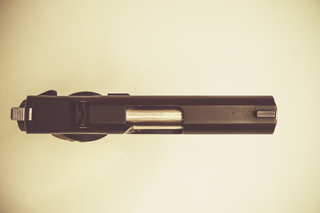 hand gun in vintage tone background - Top viewの写真素材