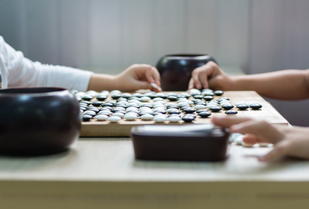 Chinese, Japan, Korean board game GO with black and white stone. Go or wei-Chi - WeiQi traditional asian board gameの写真素材