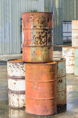 destroyed rust old metal oil barrel with bullet holes isolated on white backgroundの写真素材