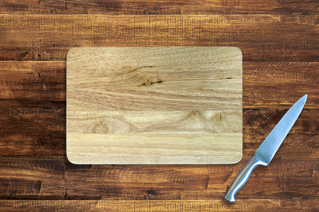 stainless kitchen knife and wood cutting board background with copy spaceの写真素材