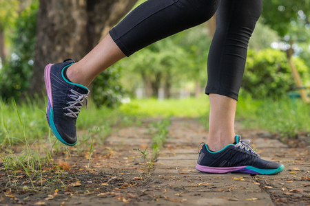 female runner feet closeup outdoor during running workout exercise. Health, fitness and excercise concept.の写真素材