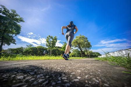 female runner jogging during outdoor workout -  running woman