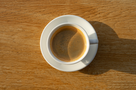 coffee in white cup on wood backgroundの写真素材