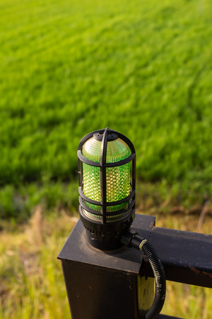wall lamp over green field background with text spaceの写真素材