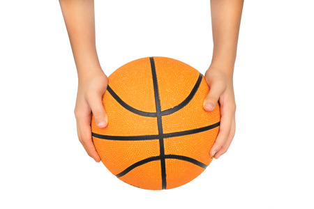 kid hands catching or passing a basketball isolated on white with clipping pathの写真素材