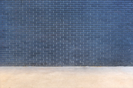 modern dark brick wall background with floorの写真素材