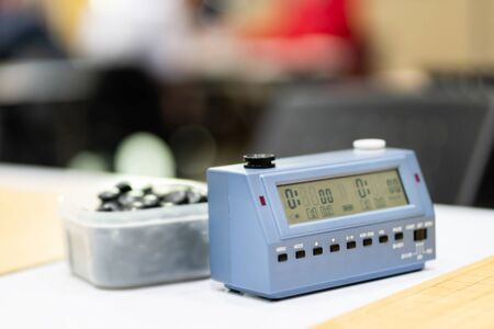 chess, baduk, weiqi, goban or broad game tournament tables with chess timers ready for players to...