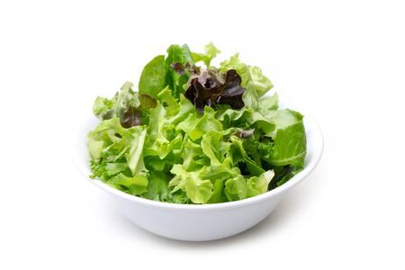 salad mixed with rucola, frisee, radicchio and lamb's lettuce  on white backgroundの写真素材
