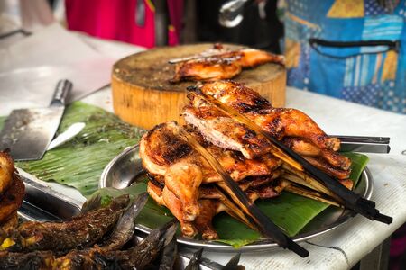 asian street food - grilled chickens on the grill pan close-upの写真素材