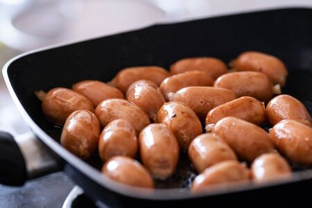 fried sausages in frying panの写真素材