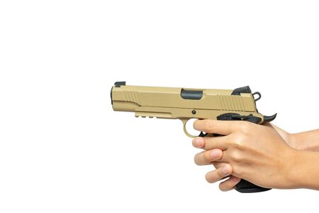 desert color pistol in hand ready to shoot on target isolated on white background with copy spaceの写真素材