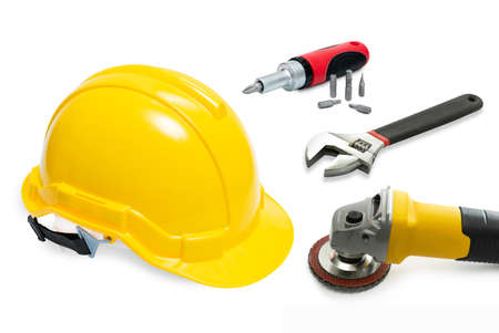 safety helmet , wrench, screw driver and grinder on white backgroundの写真素材