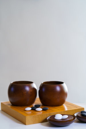 Stones of baduk game on wooden boardの写真素材
