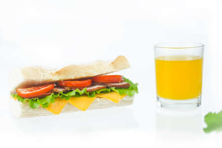 big tasty sandwich with tomato lettuce with soap and ham on white backgroundの写真素材