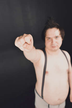 funny fat guy does physical exercises and moves in different posesの写真素材