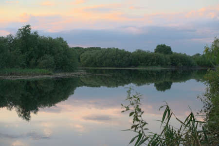 summer sunset on the banks of a large river